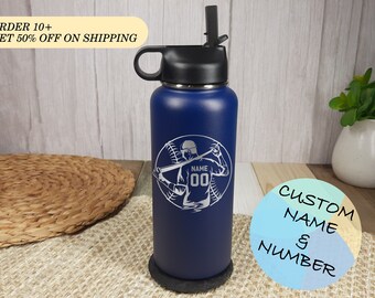 May include: A blue stainless steel water bottle with a black lid and a straw. The bottle has a laser engraved design of a baseball player with the text "NAME 00" on the front.  "CUSTOM NAME & NUMBER" is written in a circle on the right side of the image.