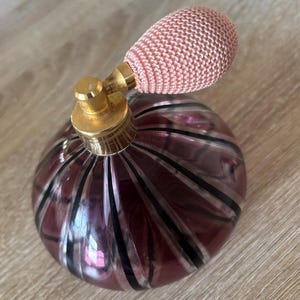 Vintage glass blown empty purple perfume bottle