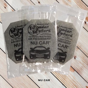 May include: Three gray car air fresheners in individual plastic bags. Each air freshener has the text "Diamond-Ultra Wonder Wafers" and "The World's Most Perfect Air Fresheners" with the words "NU CAR" printed below.