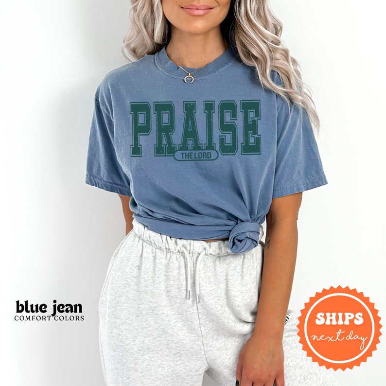a woman with grey hair wearing a blue shirt