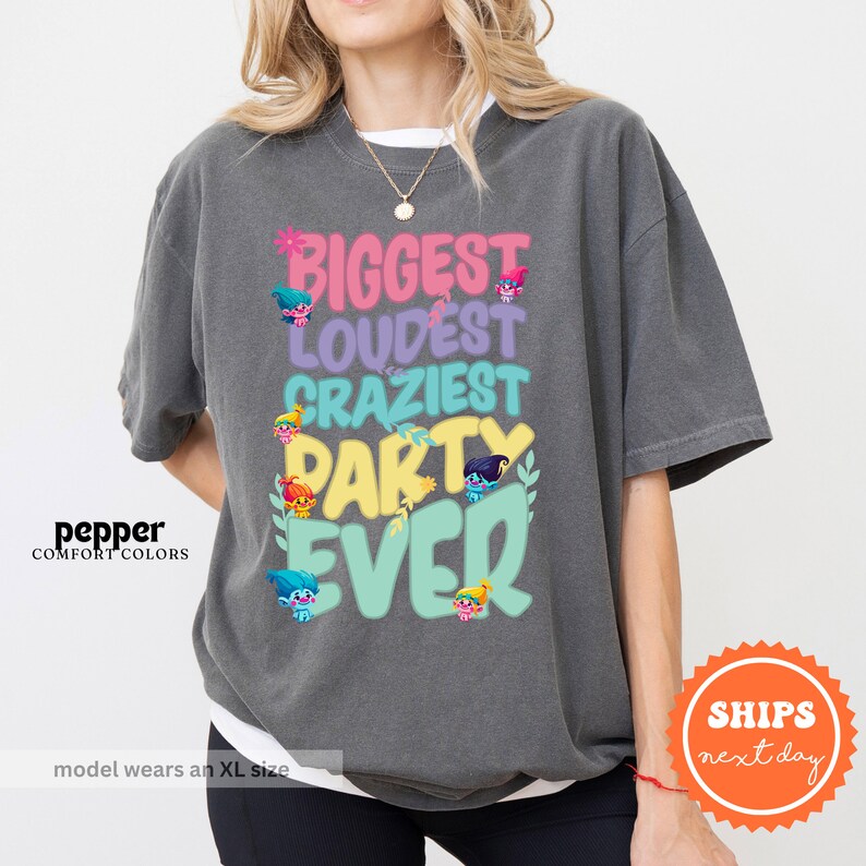 a woman wearing a t - shirt that says biggest loudest crazy party evo