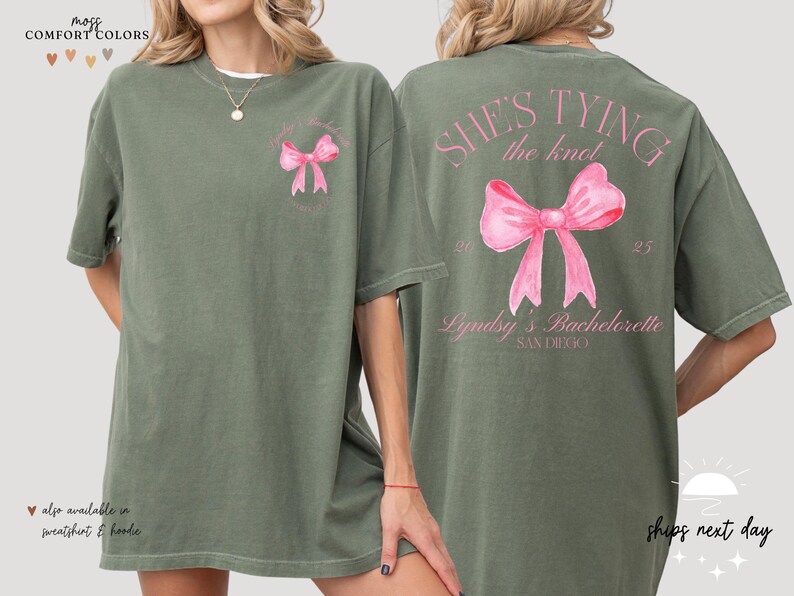 a woman wearing a green shirt with a pink bow on it