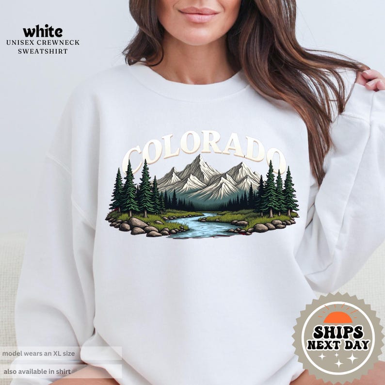 a woman wearing a white sweatshirt with the words colorado on it