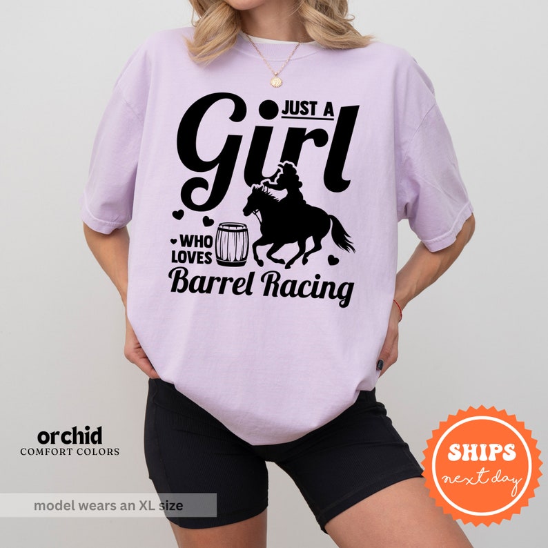 a woman wearing a shirt that says just a girl who loves barrel racing