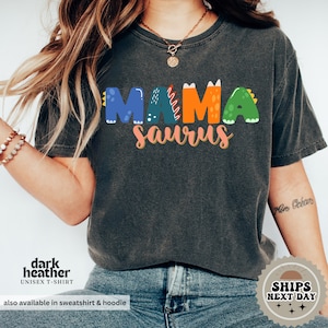 a woman wearing a black shirt with the word mama on it