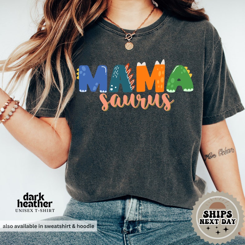 a woman wearing a black shirt with the word mama on it