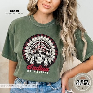 a woman wearing a green indian motorcycle t - shirt