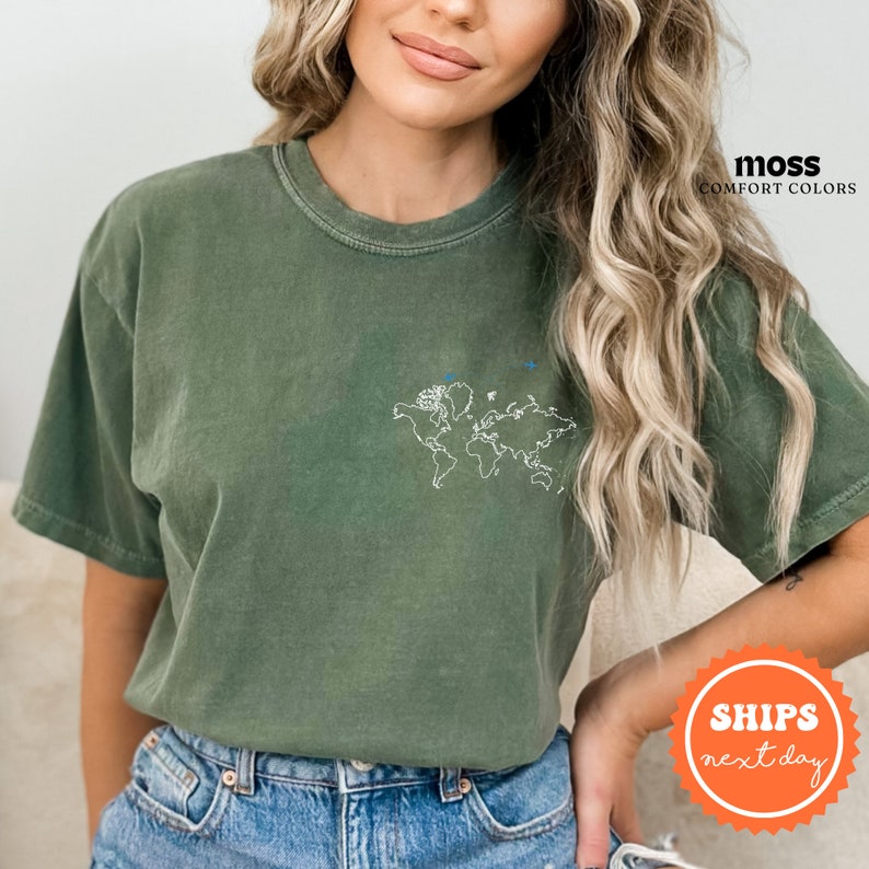 a woman wearing a green shirt and jeans