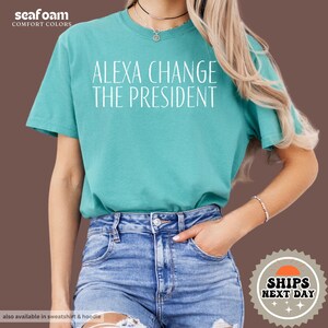 a woman wearing a t - shirt that says, alex change the president