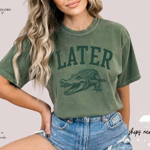 a woman wearing a t - shirt that says later