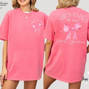 a woman wearing a pink shirt with a pink bow on it