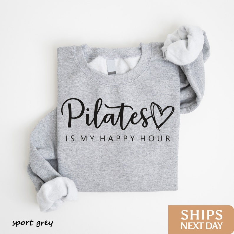 a sweatshirt with the words pilates is my happy hour printed on it