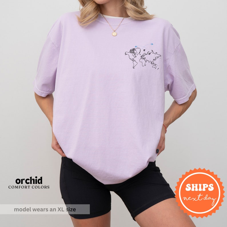 a woman wearing a purple shirt and black shorts