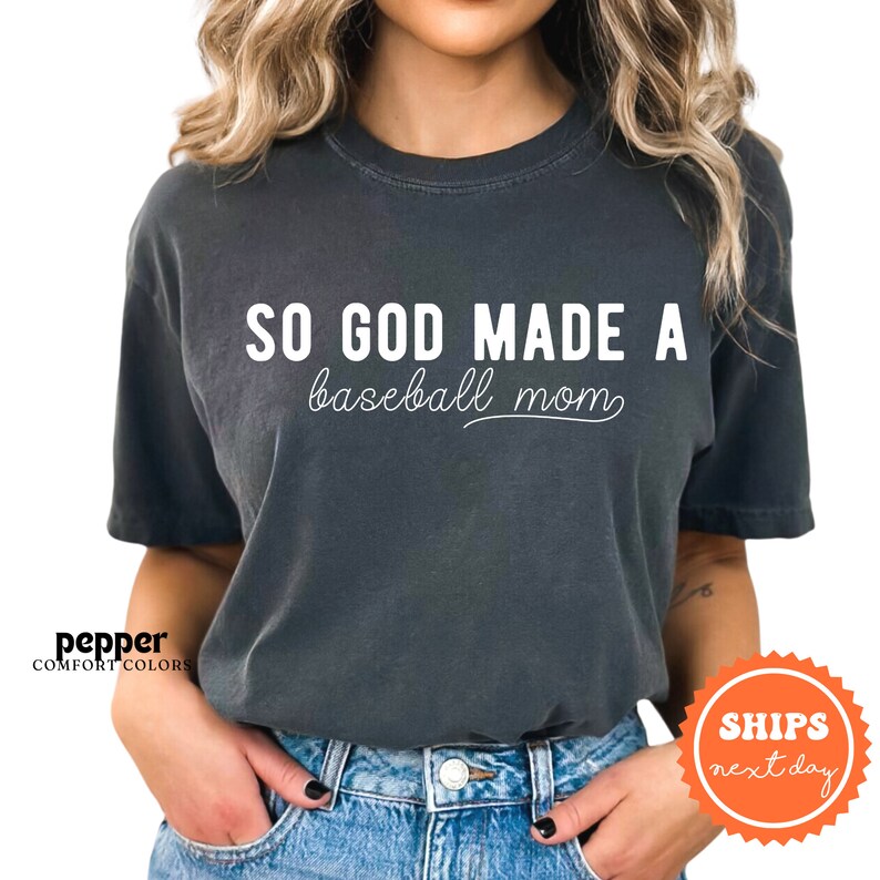 a woman wearing a black shirt that says so god made a baseball mom