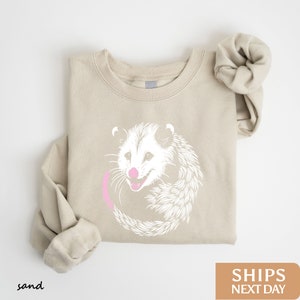 a sweater with an image of a rat on it
