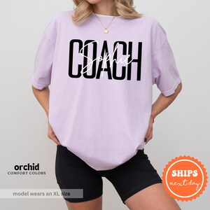 a woman wearing a shirt that says coach