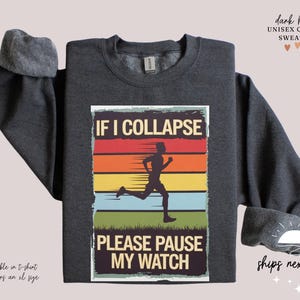 May include: Dark heather grey unisex crewneck sweatshirt with a vintage-style graphic that says "If I Collapse Please Pause My Watch" and features a silhouette of a runner against a colorful sunset.