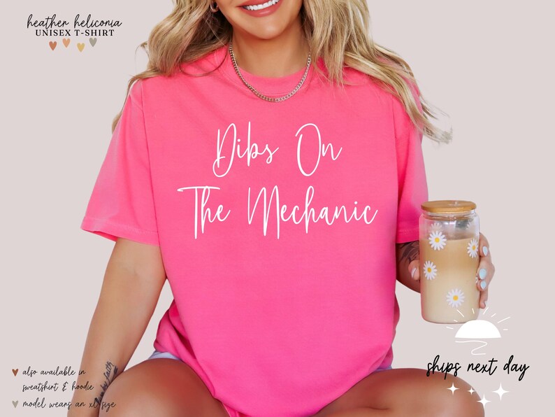 May include: Pink unisex t-shirt with the text "Dibs On The Mechanic" in white lettering.