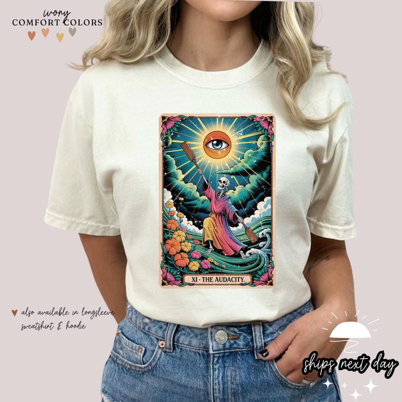 a woman wearing a white t - shirt with an image of a woman holding a