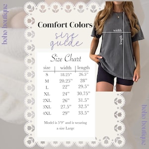 May include: A Comfort Colors size guide chart for a t-shirt, displaying width and length measurements in inches for sizes S through 4XL. The chart includes a visual diagram of a charcoal gray t-shirt with width and length lines indicated.