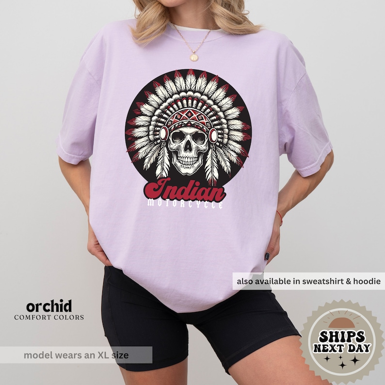 a woman wearing a t - shirt with an indian skull on it