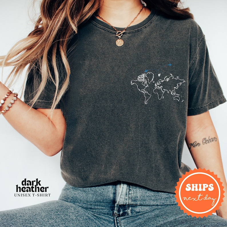 a woman wearing a black shirt with a world map on it