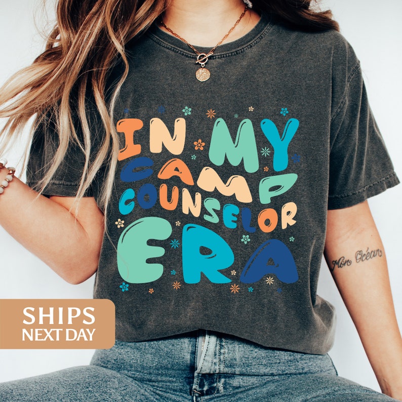 a woman wearing a t - shirt that says i'm my camp counselor era