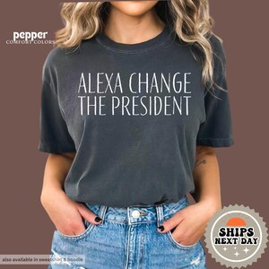 a woman wearing a t - shirt that says, alexandria change the president