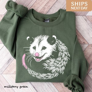 a green sweater with an image of a possle on it