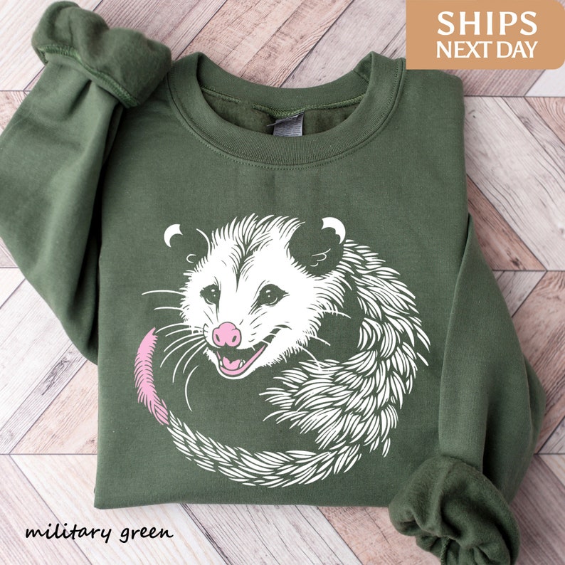 a green sweater with an image of a possle on it