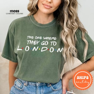 a woman wearing a green t - shirt that says the one where they go to