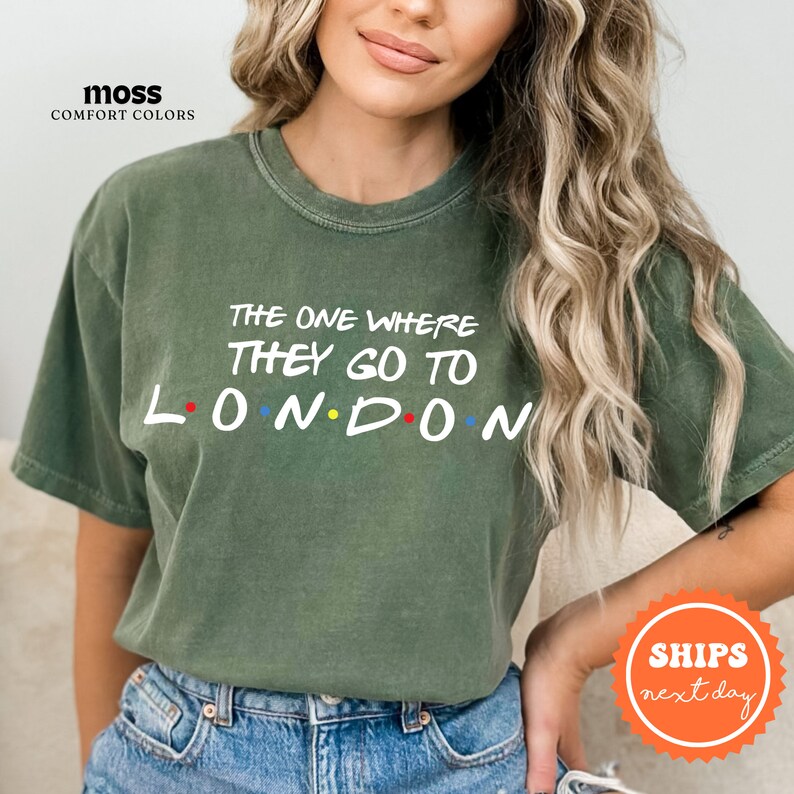 a woman wearing a green t - shirt that says the one where they go to