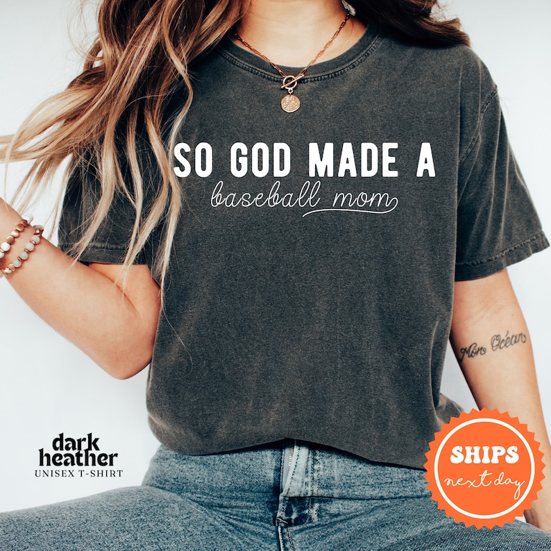 a woman wearing a shirt that says so god made a baseball mom