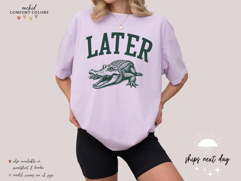 a woman wearing a white shirt with a green alligator on it