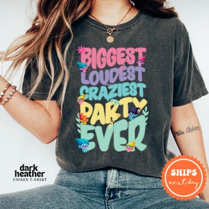a woman wearing a t - shirt that says biggest loudest crazy party ever