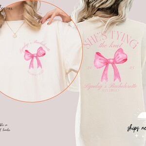 a woman wearing a t - shirt with a pink bow on it
