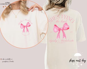 May include: White t-shirt with a pink bow and the text "Lyndsy's Bachelorette" and "She's Tying the Knot" on the front and back.