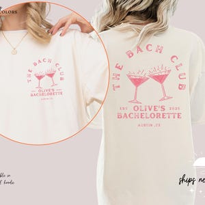 a woman wearing a white t - shirt with a pink martini on it