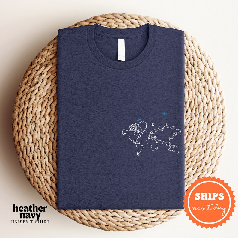 a blue t - shirt with a world map on it