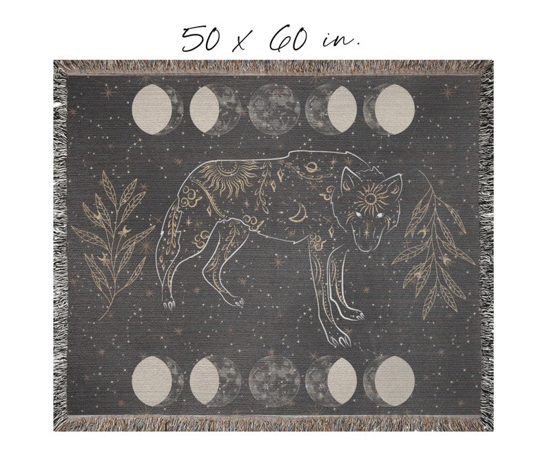 May include: A woven throw blanket with a dark gray background featuring a gold wolf silhouette with celestial and floral designs. The wolf is surrounded by a repeating pattern of gold moons and stars. The blanket measures 50 x 60 inches.