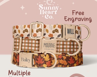 May include: Three personalized dog collars with autumn-themed patterns. The collars feature names like "Bailey," "Maddie," and "Will" engraved on the buckles. Designs include leaves, acorns, and plaid. The image also includes the text "Free Engraving."