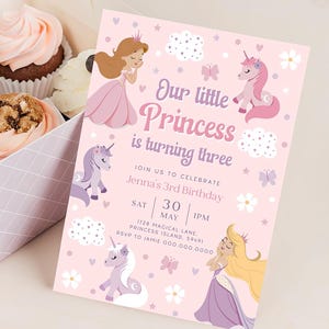 May include: A pink birthday invitation with princess and unicorn illustrations. The text reads "Our little Princess is turning three." Cupcakes in a box are visible in the background. The invitation includes the date, time, and location.