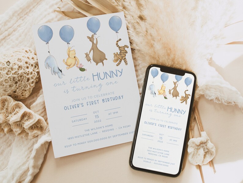 May include: Blue and white Winnie the Pooh themed first birthday invitation with a blue balloon and a line of characters including Winnie the Pooh, Piglet, Eeyore, Tigger, and Kanga. The invitation includes the text "our little HUNNY is turning one" and "Oliver's First Birthday".