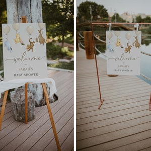 Op de afbeelding: Twee welkomstborden voor een babyshower met een Winnie de Poeh-thema. De borden bevatten illustraties van Winnie de Poeh, Biggetje, Tijger en Eeyore. E&eacute;n bord staat op een ezel en het andere op een koperen standaard.