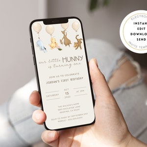May include: A digital invitation on a smartphone screen for a first birthday party. The invitation features a Winnie the Pooh theme with illustrations of Winnie the Pooh, Piglet, Tigger, and Eeyore. The text reads "our little Hunny is turning one" and includes details about the party, such as the date, time, and location.