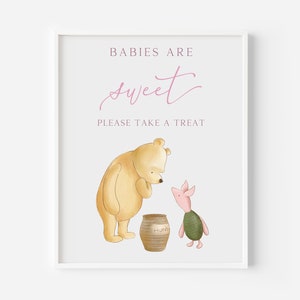 May include: A Winnie the Pooh and Piglet themed sign that says "Babies are sweet. Please take a treat."  Winnie the Pooh is standing next to a honey pot and Piglet is standing next to him.