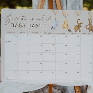May include: A white calendar with a Winnie the Pooh theme for a baby shower. The calendar has the months of April and May with the days of the week listed. The due date is marked with a heart on April 13th. The text "Guess the arrival of Baby Jamie" is at the top of the calendar.