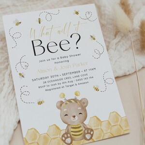 May include: A white baby shower invitation with a cute cartoon bear wearing a bee costume. The invitation says "What will it Bee?" and includes details about the shower, including the date, time, location, and RSVP information.