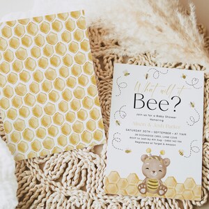 May include: A baby shower invitation with a yellow and white honeycomb pattern and a cartoon bear wearing a bee costume. The text on the invitation reads "What will it Bee?" and includes the date, time, and location of the event.