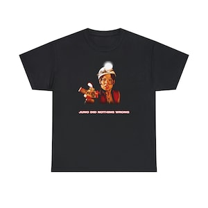 May include: Black t-shirt with a graphic of a woman wearing a hard hat and holding a gun. The text "JUNO DID NOTHING WRONG" is printed below the graphic.